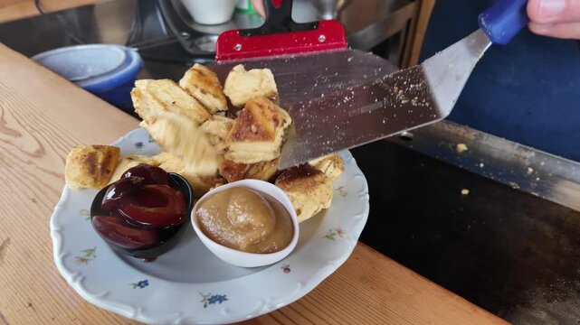 Serving fresh Kaiserschmarrn pancake on plate