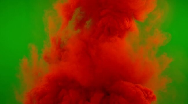 Vibrant Red Smoke Cloud Erupting Upwards Against A Bright Green Screen Background With Dynamic Swirling Patterns And Soft Lighting