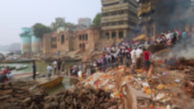 Bokeh view of Manikarnika Ghat is one of the ghats and is most known for being a place of Hindu cremation in Varanasi, India. Blurred background footage.