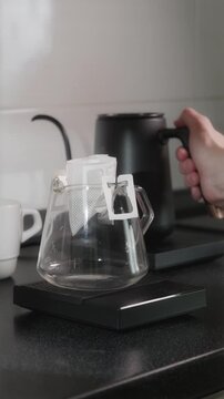 First pour over drip coffee bag on glass server