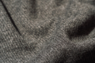 Gray ribbed knit fabric with soft folds. © Anastassiya 