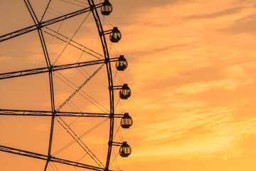 Ferris wheel silhouette against a beautiful sunset sky © iban