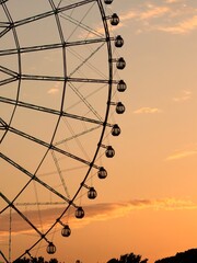 Ferris wheel silhouette against a beautiful sunset sky © iban