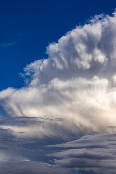 Dramatic white clouds in sunlight on blue sky