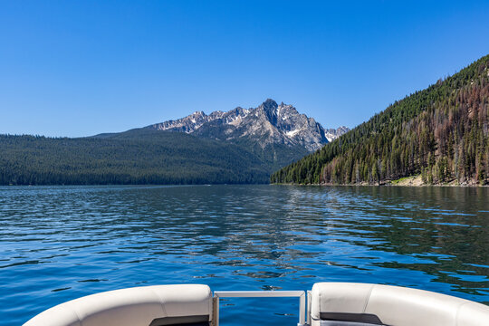 View over prow of boat on Redfish Lake towards Sawtooth Mountains