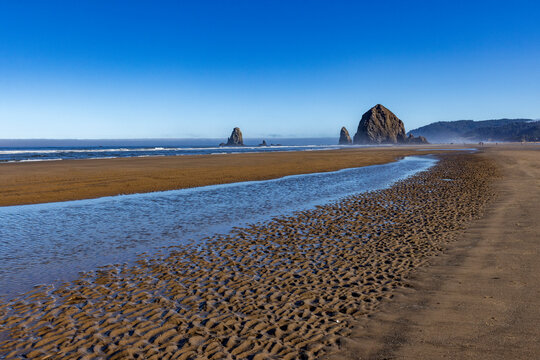 Cannon Beach at low tide with Haystack Rock in background