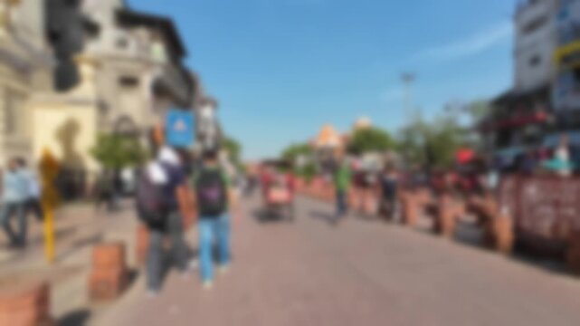 Blurred view of the Chandni Chowk Road leading to the famous Red Fort in Delhi, India, on a sunny day. Motionlapse video for background.