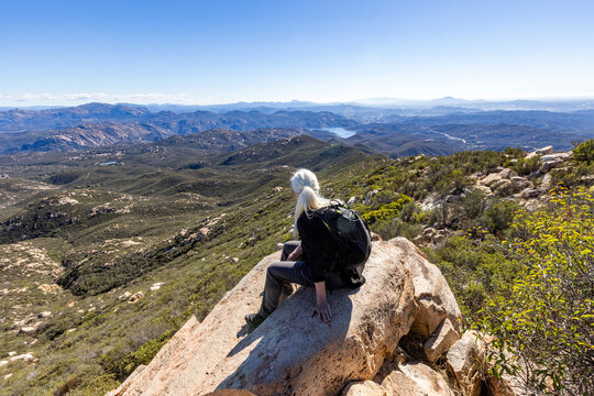 Senior blond hiker looking at view from top of Iron Mountain