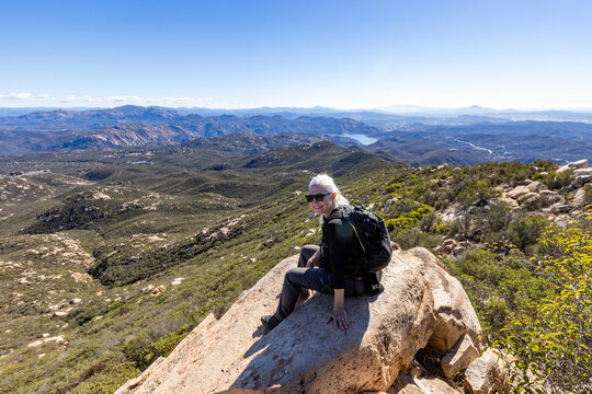 Senior blond hiker looking at view from top of Iron Mountain