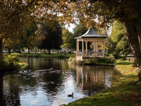 Tranquil park scene with a bandstand on a lake in autumn colors