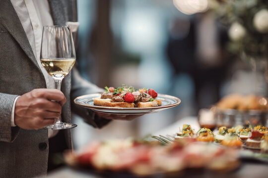 Elegant Finger Food Presentation at a Sophisticated Event with Guest Holding