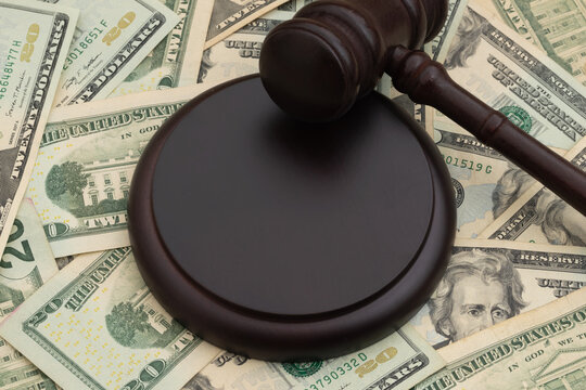 Judge gavel and block and on twenty dollar bills for legal fees and court costs
