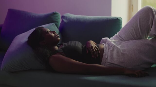 African American woman picking up smartphone then reacting with anger to message, rejecting content and pulling away with frustration, expressing strong negative response to digital interaction