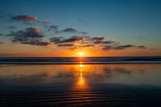 Sun setting over calm ocean