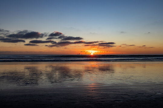 Sun setting over calm ocean