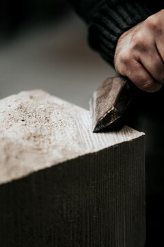 stone mason is working with different tools like chisel, mallet or hammer