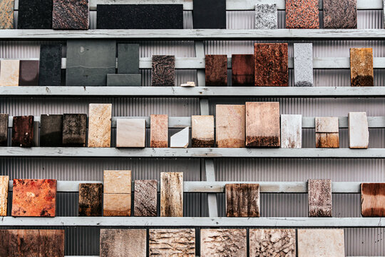 A wall covered with various stone patterns made from different types of stone