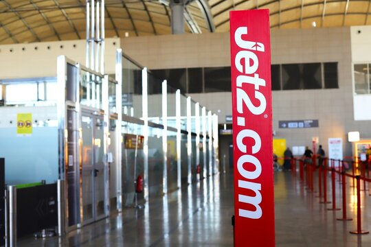 Alicante, Spain - October 14, 2025: Jet2.com sign in airport terminal with check-in counters and modern architecture visible in the background