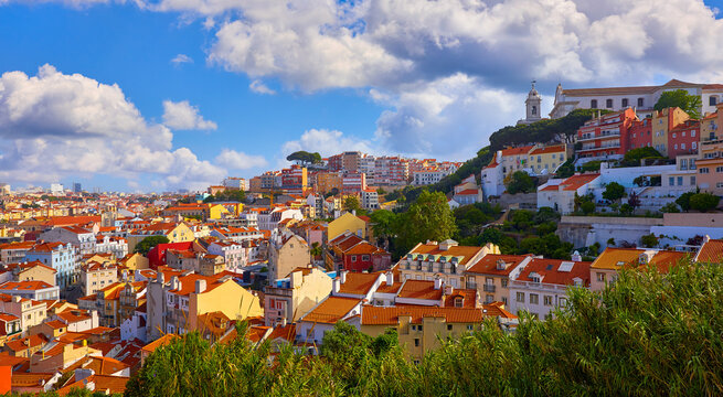 Lisbon, Portugal. Panoramic view of historic old town in district Alfama during evening sunset time. beautiful summer sky and sunny light at houses roofs. Popular travel destination in Europe
