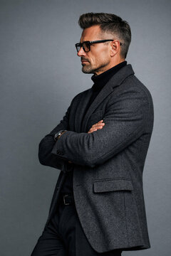 A handsome man exudes confidence in a fashionable outfit and shades.