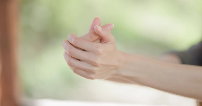 Hands perform delicate movements showcasing flexibility and grace during a creative activity in a serene outdoor setting at sunset