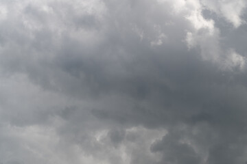 Fototapeta premium Clouds shift dramatically. Overcast sky with moving layers. Dark gray clouds create striking visual contrast. Thick gray cloud formations flow across scene dynamically
