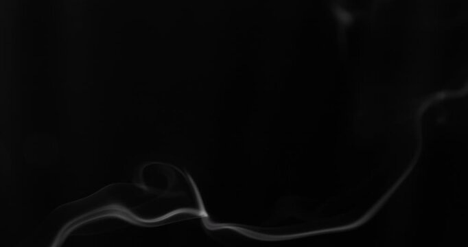 Detailed slow motion rising smoke isolated on black background. Cinematic fog overlay with soft swirling motion, ideal for VFX compositing, transitions and atmosphere.
