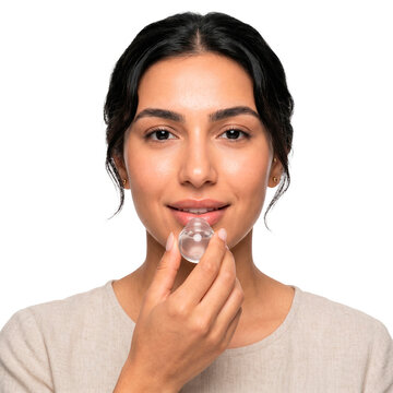 Woman applying lip enhancer tool for fuller lips beauty treatment on transparent background