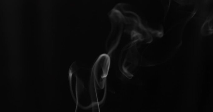 Detailed slow motion rising smoke isolated on black background. Cinematic fog overlay with soft swirling motion, ideal for VFX compositing, transitions and atmosphere.