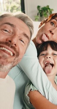 Selfie, silly face and family in home for social media post, memory and bonding. Love, photography pov and profile picture with parents and girl in house for connection, humor and funny or tongue out