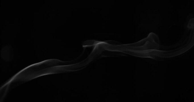 Detailed slow motion rising smoke isolated on black background. Cinematic fog overlay with soft swirling motion, ideal for VFX compositing, transitions and atmosphere.