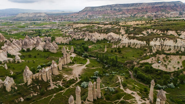High angle aerial view of unique phallic fairy chimney rock formations in Love Valley, scenic geological canyon landscape near Goreme in the Cappadocia region, Turkey