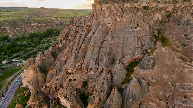 aerial massive steep volcanic cliffs containing Selime Cathedral caves. Historic rock-cut christian monastery structure in Cappadocia, Turkey