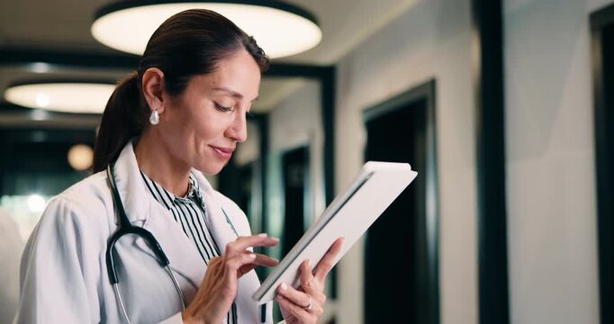 Tablet, doctor and woman in hospital for healthcare, report and thinking with patient history. Mature, medical person and typing with digital tech for telehealth, reflection and schedule in clinic