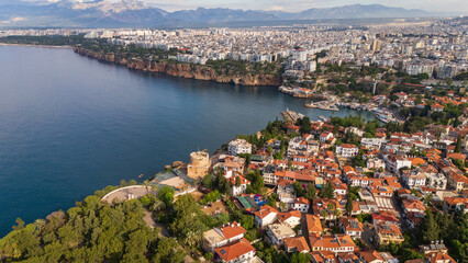 Naklejka premium drone aerial of Antalya marina harbor bay and the steep coastal cliffs. Beautiful marine landscape and Mediterranean resort town lifestyle scenery in Turkey