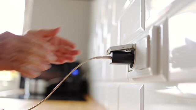 Senior Woman Charging Mobile Phone at Home
