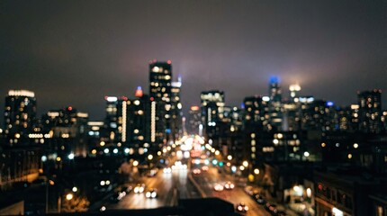 Fototapeta premium Sad lofi boy sitting by window on rainy night concept. Blurred city skyline at night with glowing lights and busy streets.