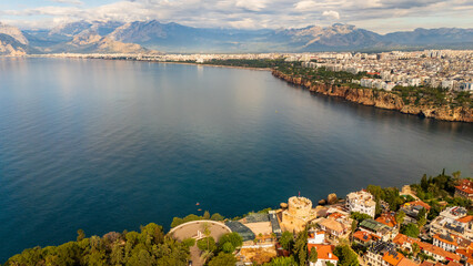 Naklejka premium drone aerial of Antalya marina harbor bay and the steep coastal cliffs. Beautiful marine landscape and Mediterranean resort town lifestyle scenery in Turkey