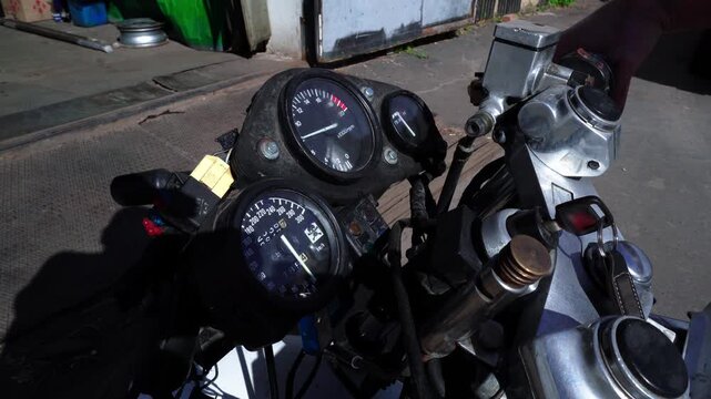 sports retro motorcycle disassembled for repair and adjustment of carburetors, engine start and check at high rpm, testing