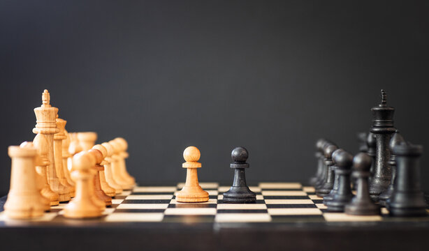 chess pieces on a chessboard on a dark background