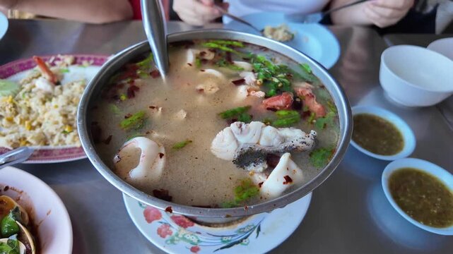 Spicy Seafood Soup: A vibrant bowl of spicy seafood soup, brimming with fresh ingredients and aromatic herbs, promises a flavorful culinary experience.