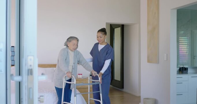 Senior Asian woman sitting bedside female caregiver in scrubs moving walker guiding steps to bath