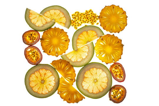 Composition of longitudinal and transverse cuts of fruits of various shapes on the lumen isolated on white background.