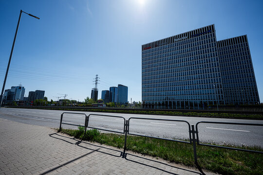 Modern business office towers and empty urban street in Katowice, Poland with clear blue sky and sunlight