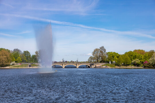 View of Lombard Bridge and Alster Fountain in Hamburg, Germany on a clear day.