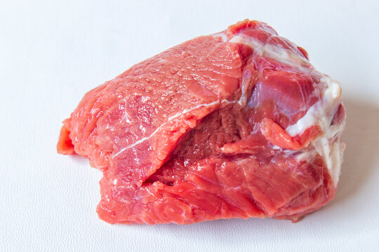 Fresh raw beef meat isolated on white background. Large piece of buffalo meat filet closeup. Raw beef steak isolated on white background