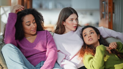 Obraz premium Multiracial friends sharing conversation sitting comfortable home sofa closeup. 