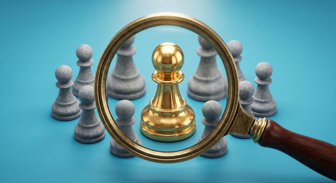 Gold Chess Pawn Highlighted Through Magnifying Glass Among Gray Pieces