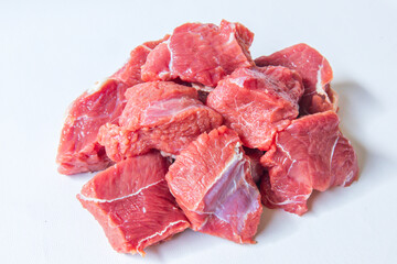 Obraz premium Fresh raw chopped lamb fillet isolated on White Background. Sheep fillet cubes, loin filet for skewers. Diced tenderloin or cubed mutton sirloin meat.