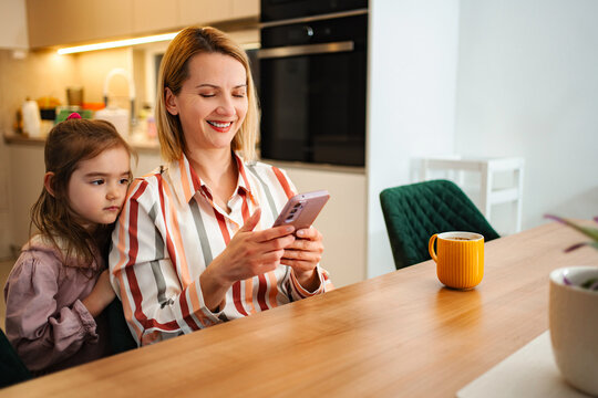 Mother ignoring child while scrolling social media on phone
